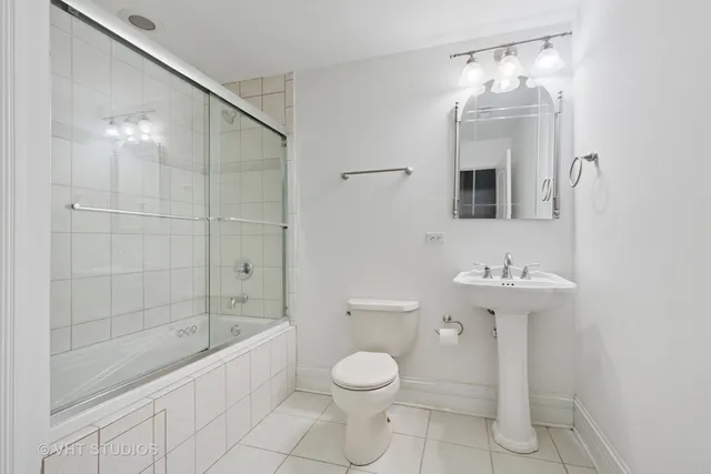 a bathroom with a toilet sink and shower