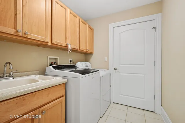 a utility room with sink dryer and washer