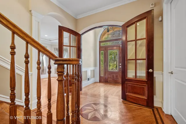 a view of an entryway with wooden floor and door