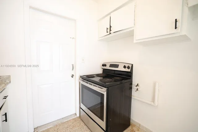 a kitchen with a stove and a microwave