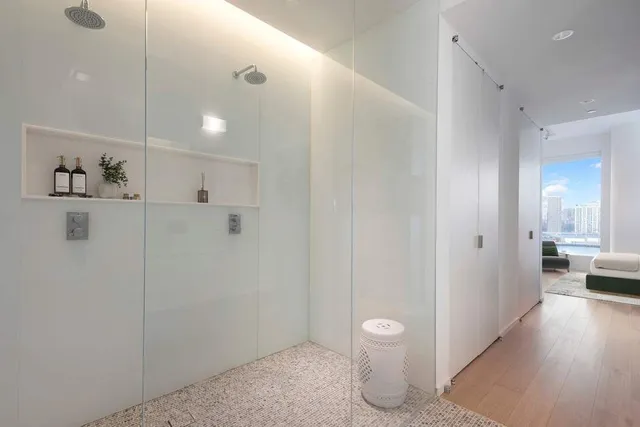 a bedroom with a bed mirror and a couch