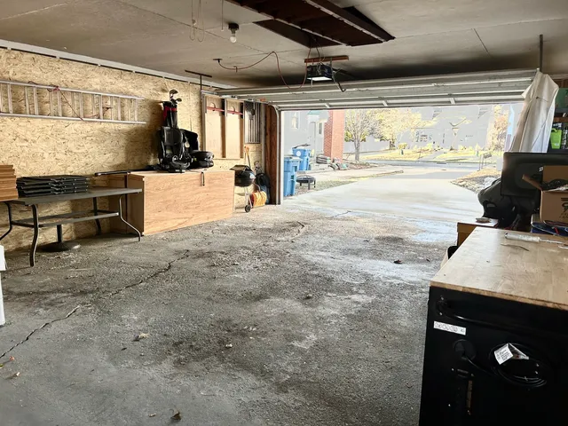 a view of a white house with a yard and garage