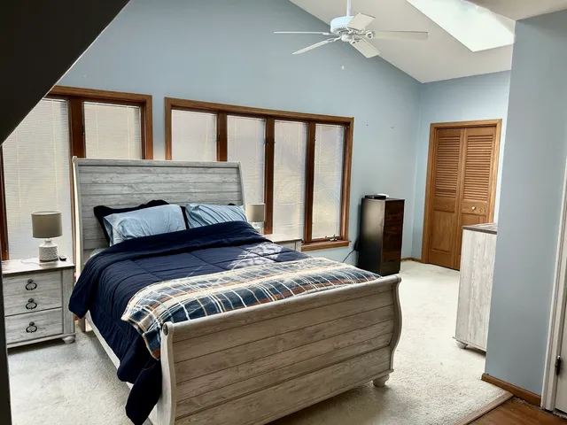 a bedroom with a bed and a window