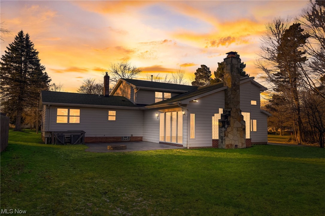 471 Snavely Road Cleveland, OH 44143 - Photo 3 of 35 Back house at dusk featuring a yard, a patio, and a fire pit