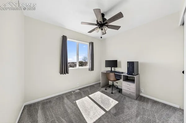 a bathroom with a granite countertop sink toilet a mirror and shower