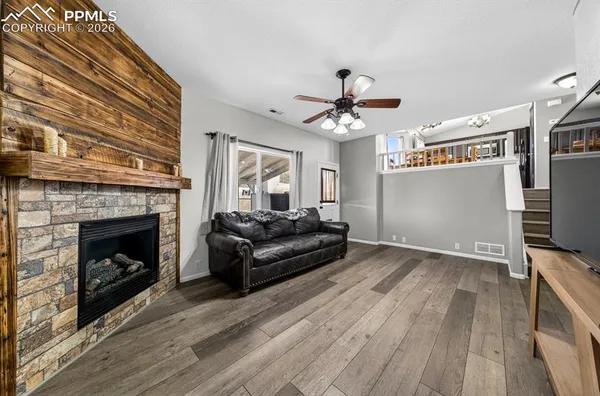 a living room with furniture a fireplace and a flat screen tv