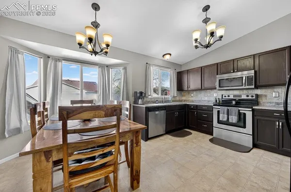 a dining room with furniture and window