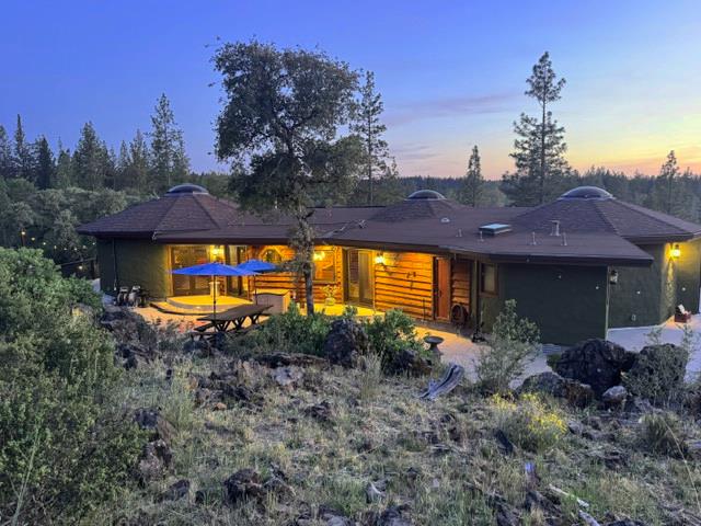 12767 Newtown Road Nevada City, CA 95959 - Photo 2 of 57 a view of a house with a yard and potted plants