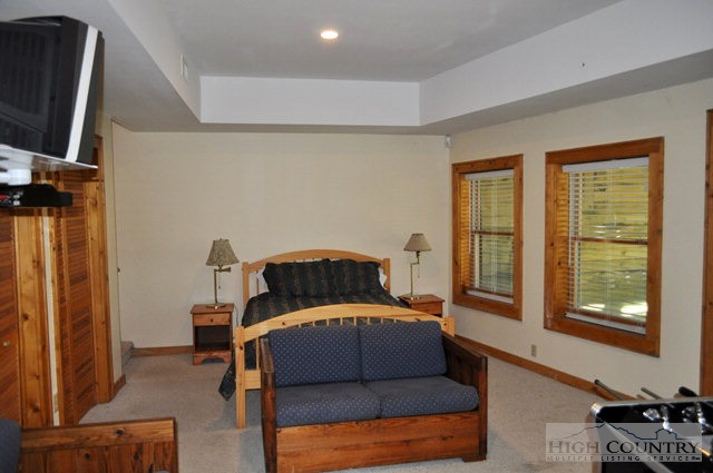 346-348 Grady Winkler Road Boone, NC 28607 - Photo 5 of 32 a bedroom with a bed and wooden floor