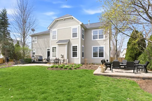 a front view of a house with sitting area and garden