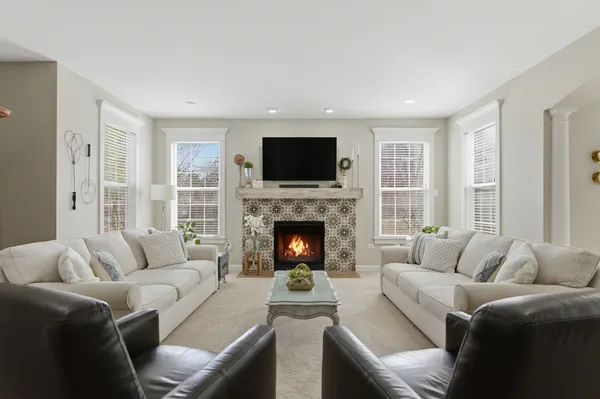a living room with furniture a flat screen tv and a fireplace