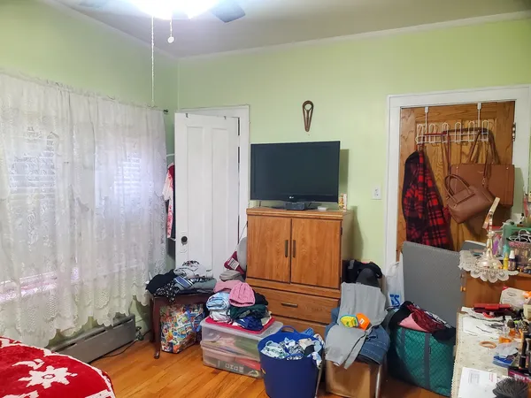 a bedroom with a bed and painting on the wall