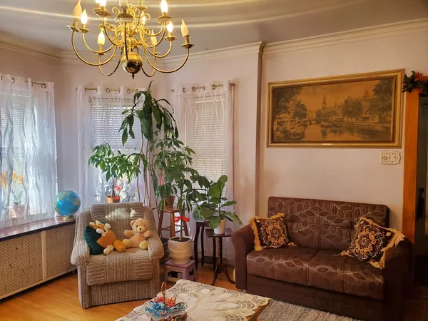 a view of a dining room with furniture and chandelier