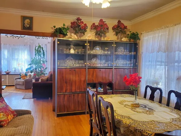 a dining room with furniture and wooden floor