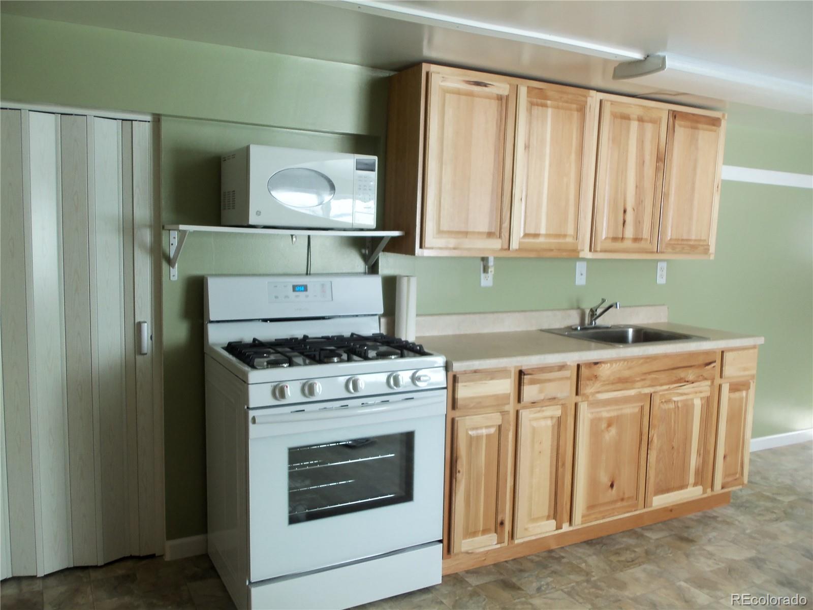 59501 County Rd GG Moffat, CO 81143 - Photo 11 of 25 a kitchen with a stove and a sink