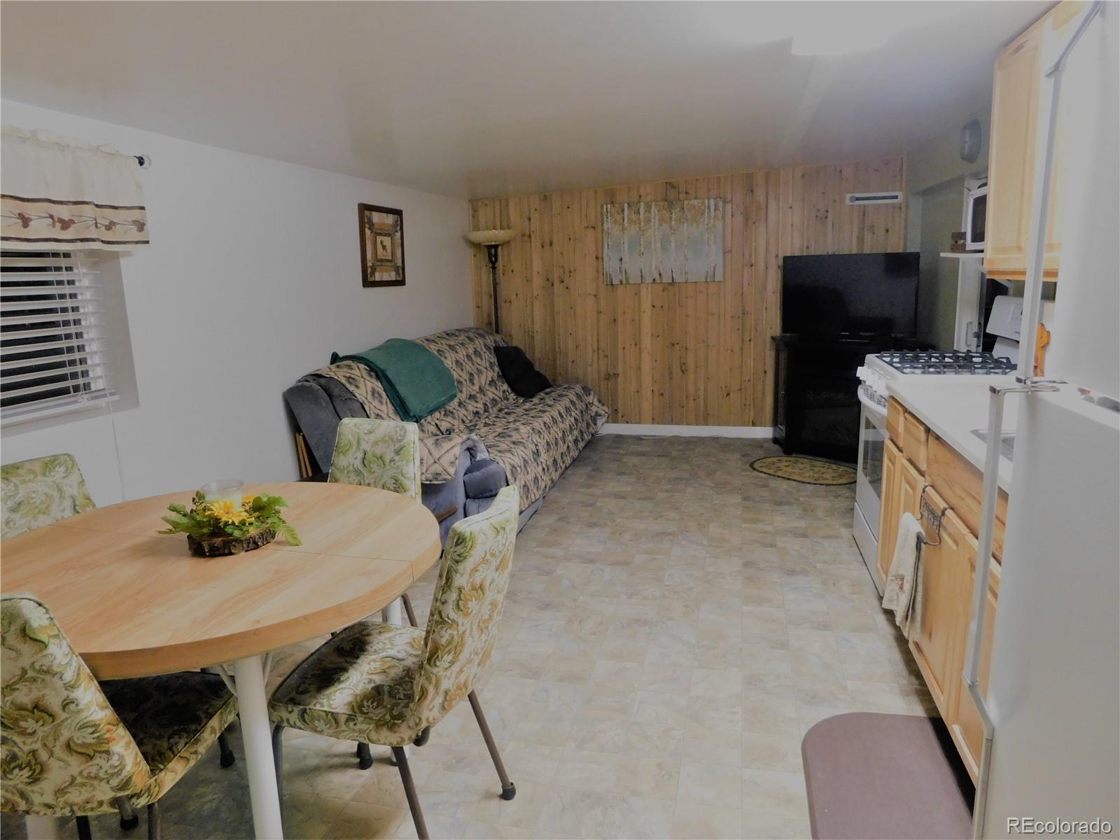 59501 County Rd GG Moffat, CO 81143 - Photo 13 of 25 a living room with furniture and a table