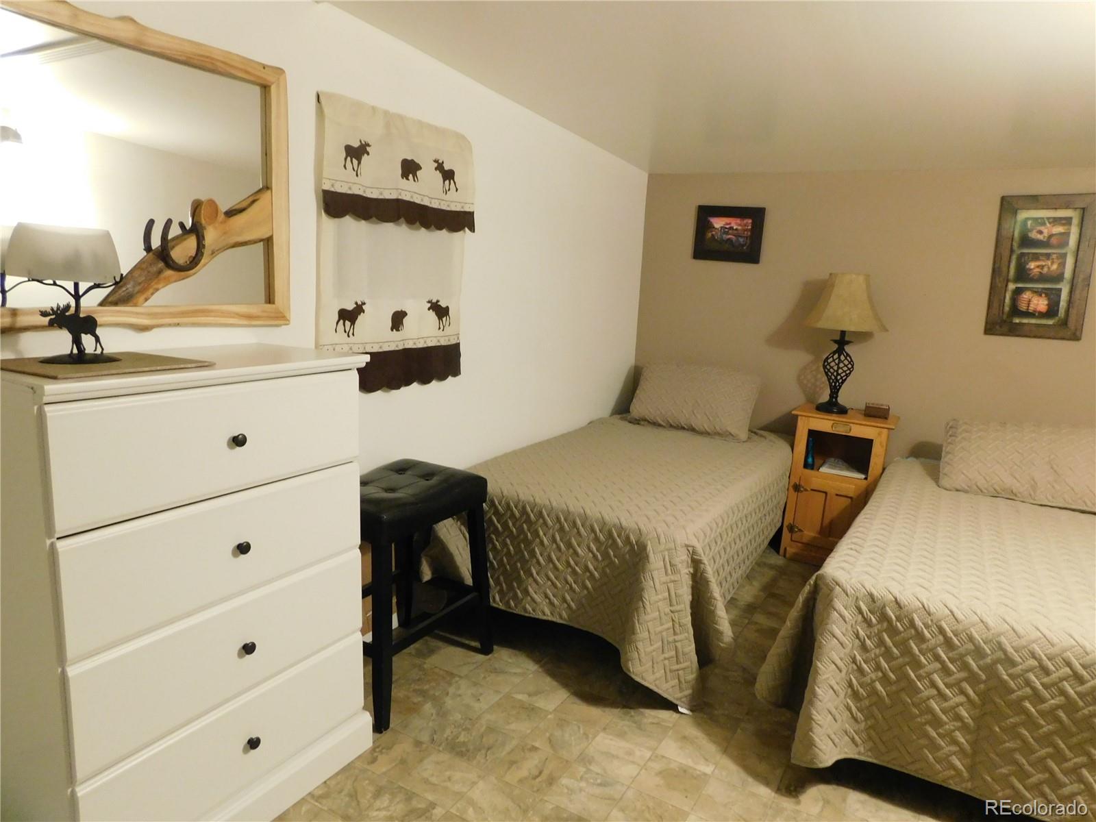 59501 County Rd GG Moffat, CO 81143 - Photo 14 of 25 a bedroom with a bed and a dresser