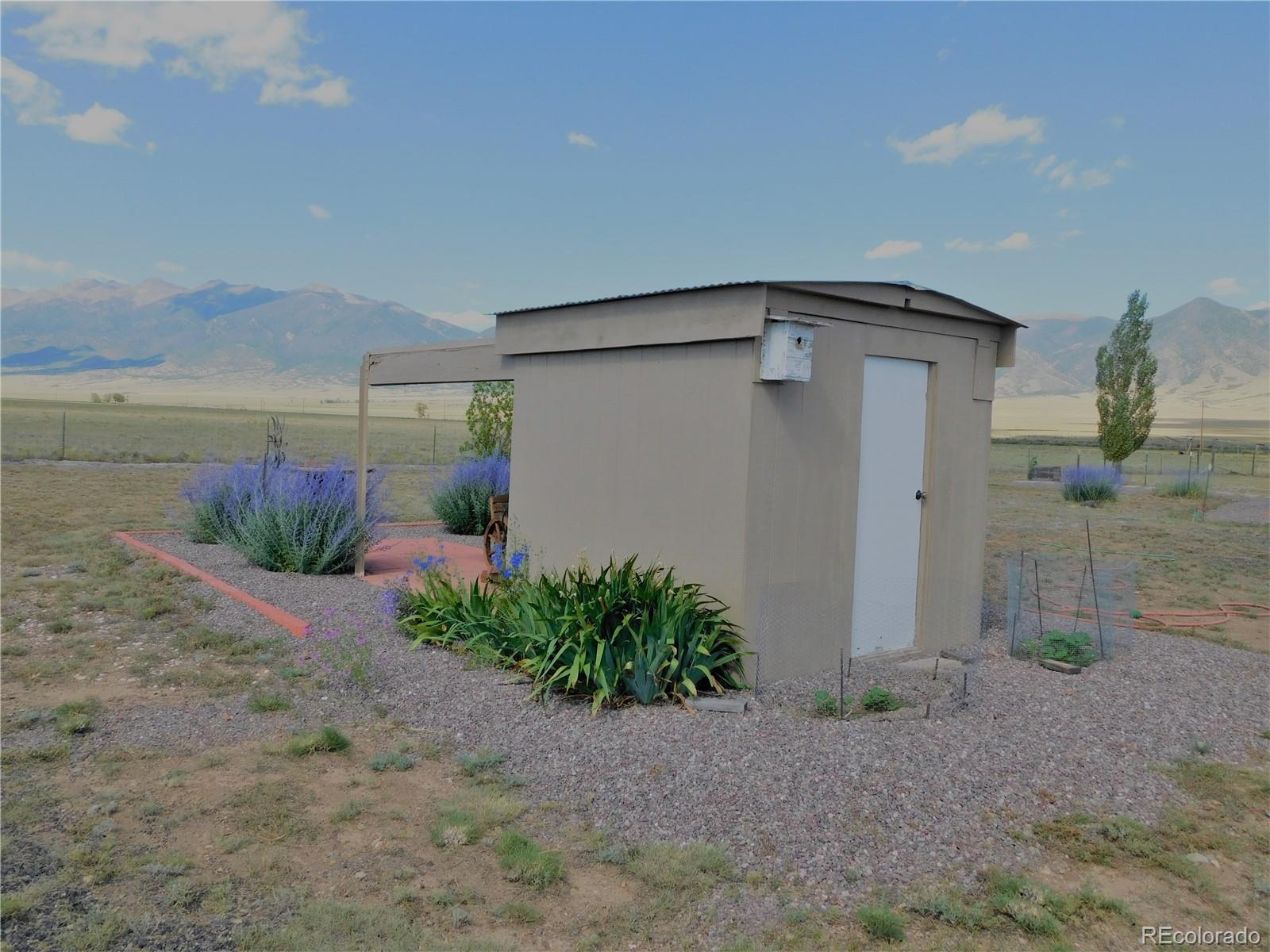 59501 County Rd GG Moffat, CO 81143 - Photo 22 of 25 a front view of a house with garden