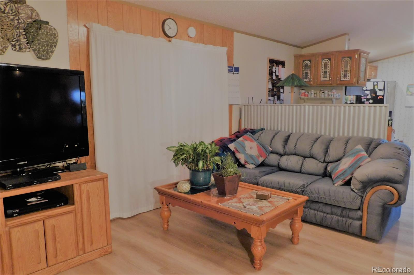 59501 County Rd GG Moffat, CO 81143 - Photo 4 of 25 a living room with furniture flat screen tv and potted plant