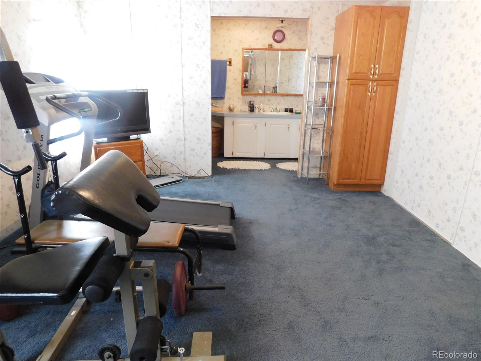 59501 County Rd GG Moffat, CO 81143 - Photo 8 of 25 a living room with furniture and a flat screen tv