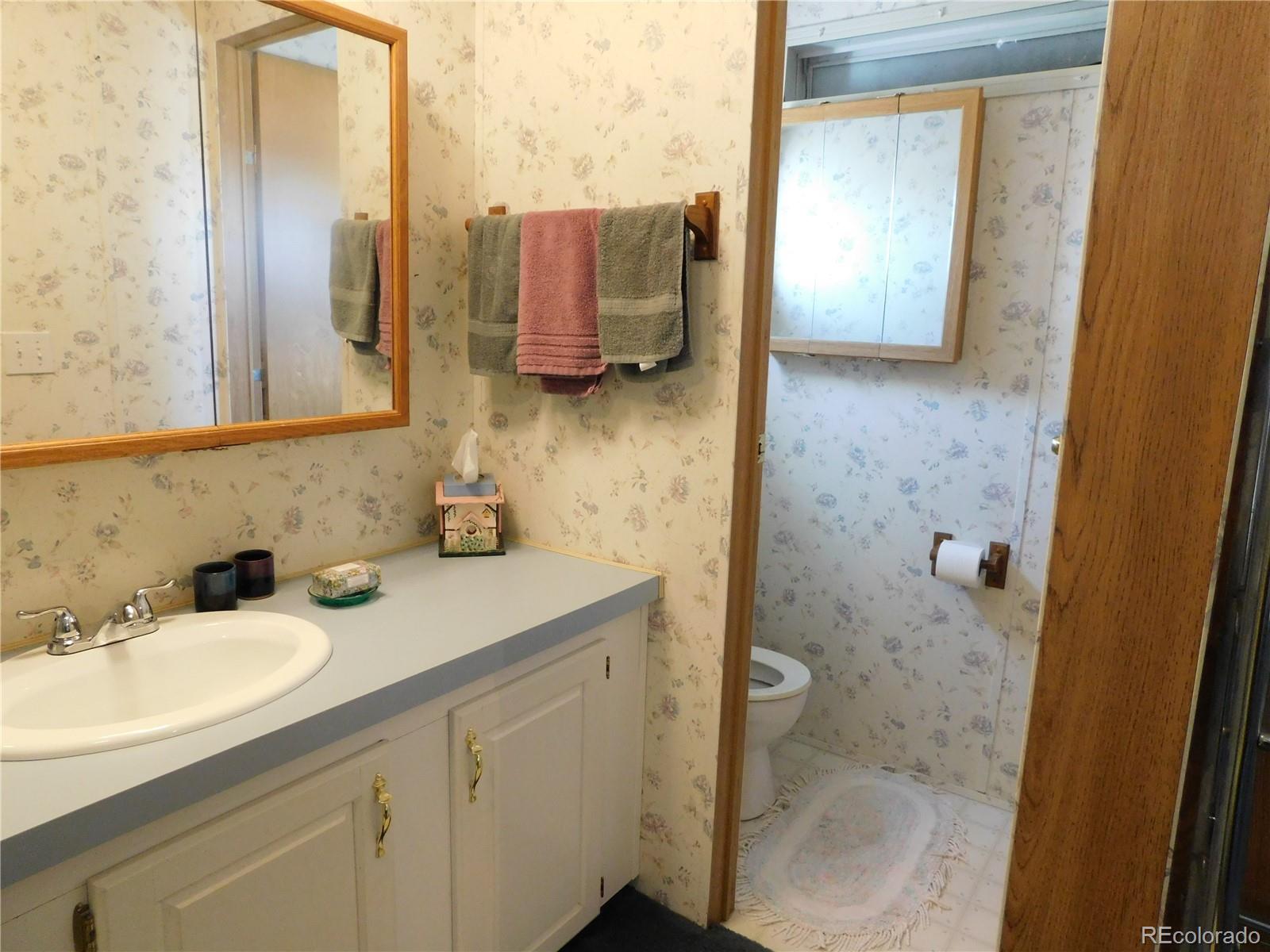 59501 County Rd GG Moffat, CO 81143 - Photo 9 of 25 a bathroom with a sink a mirror and shower