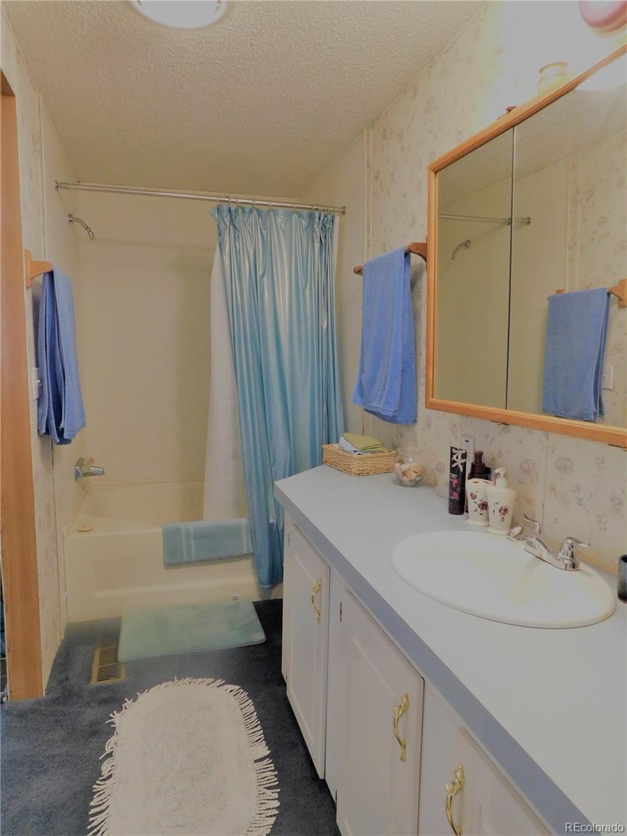 59501 County Rd GG Moffat, CO 81143 - Photo 10 of 25 a bathroom with a sink a toilet and shower