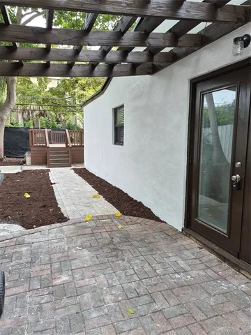 a view of a swimming pool with a patio and a yard