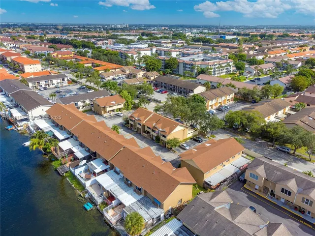 an aerial view of residential houses with outdoor space