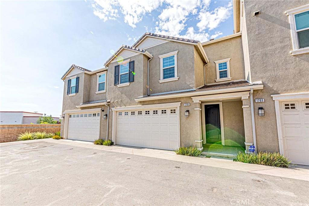 1705 Almond Tree Place Upland, CA 91784 - Photo 1 of 41 a front view of a house with a yard and garage