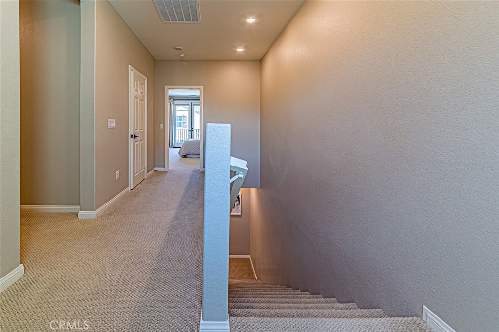 1705 Almond Tree Place Upland, CA 91784 - Photo 14 of 41 a view of a hallway with wooden floor and staircase