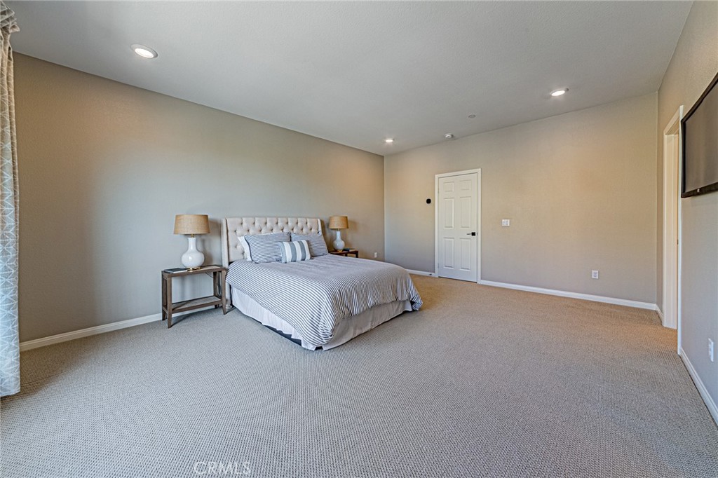 1705 Almond Tree Place Upland, CA 91784 - Photo 17 of 41 a bedroom with a bed and a lamp