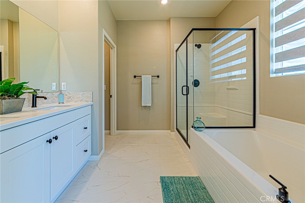 1705 Almond Tree Place Upland, CA 91784 - Photo 18 of 41 a bathroom with a shower sink and mirror