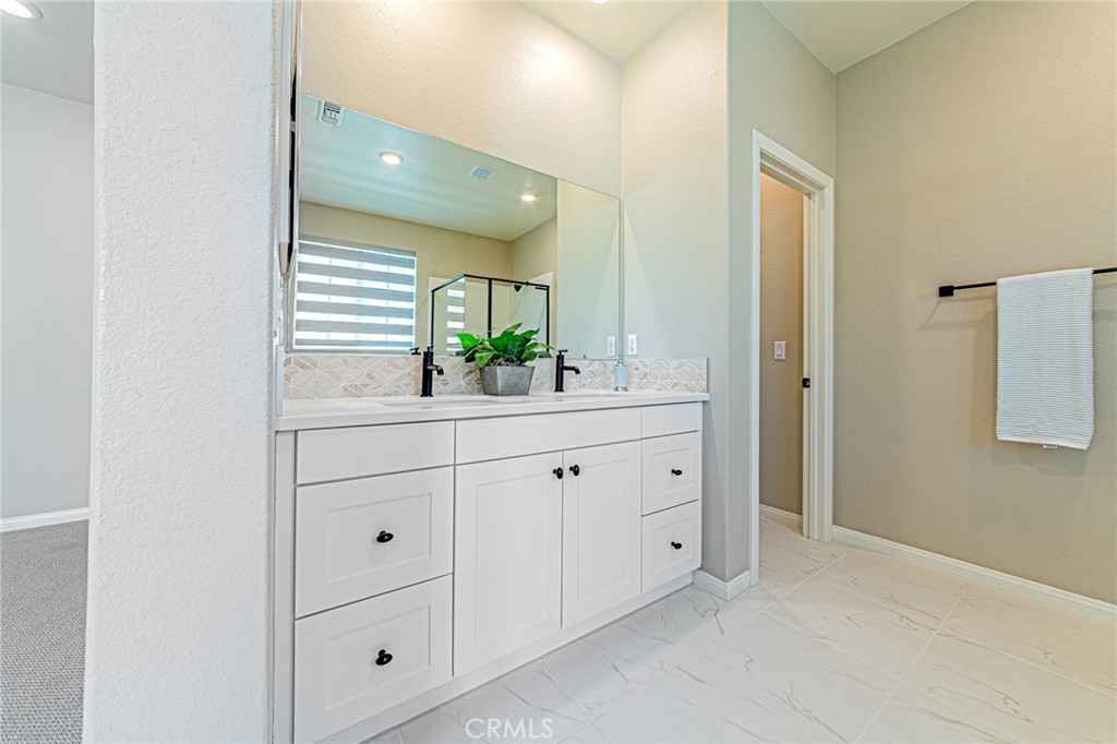 1705 Almond Tree Place Upland, CA 91784 - Photo 19 of 41 a bathroom with a double vanity sink and mirror
