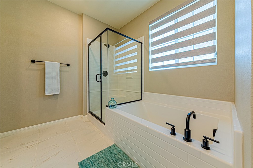 1705 Almond Tree Place Upland, CA 91784 - Photo 20 of 41 a bathroom with a sink a glass door and shower