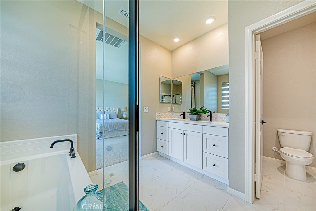 1705 Almond Tree Place Upland, CA 91784 - Photo 21 of 41 a bathroom with a granite countertop sink mirror and toilet