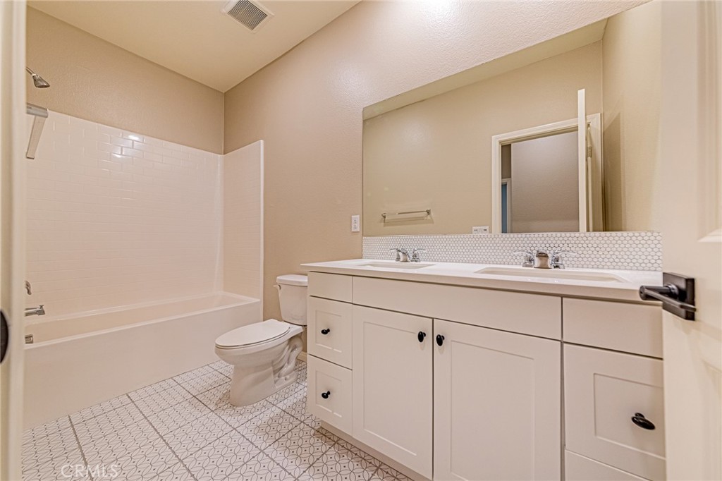 1705 Almond Tree Place Upland, CA 91784 - Photo 28 of 41 a bathroom with a sink a toilet a mirror and shower