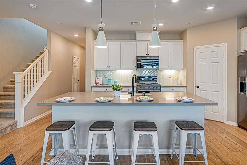 1705 Almond Tree Place Upland, CA 91784 - Photo 3 of 41 a kitchen with stainless steel appliances granite countertop a sink and a refrigerator