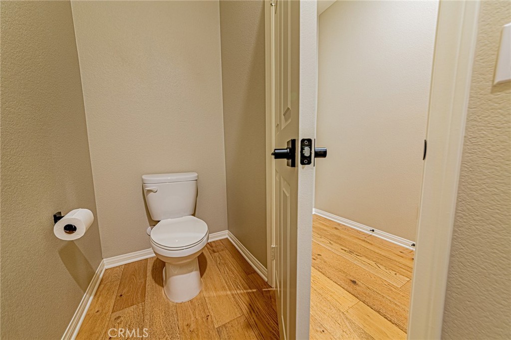 1705 Almond Tree Place Upland, CA 91784 - Photo 32 of 41 a bathroom with a granite countertop toilet and a sink