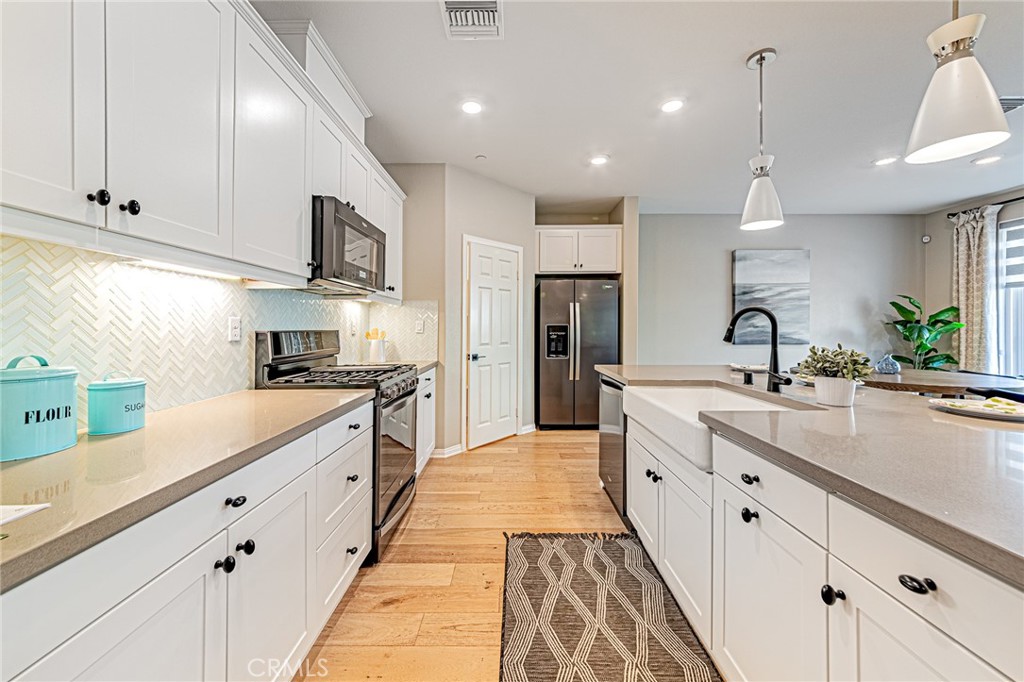 1705 Almond Tree Place Upland, CA 91784 - Photo 5 of 41 a large kitchen with kitchen island a sink stainless steel appliances and cabinets