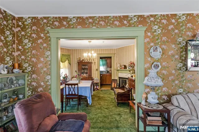 a living room with furniture and a painting on the wall