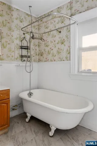 a bathroom with a bathtub and shower