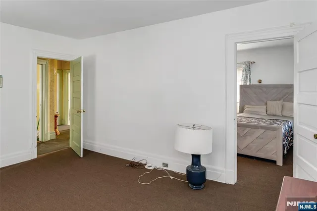 a view of hall way with mirror and furniture