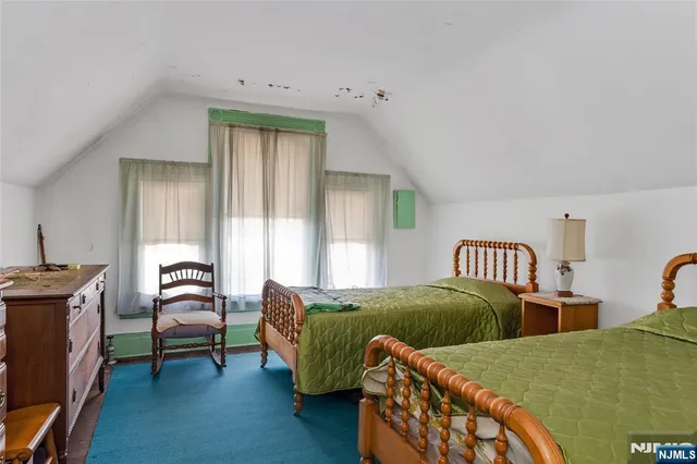 a bedroom with two beds and a couch