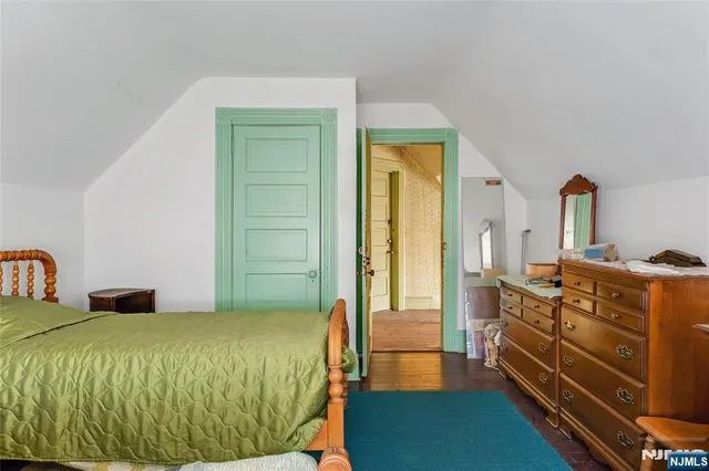 a bedroom with a bed and a dresser