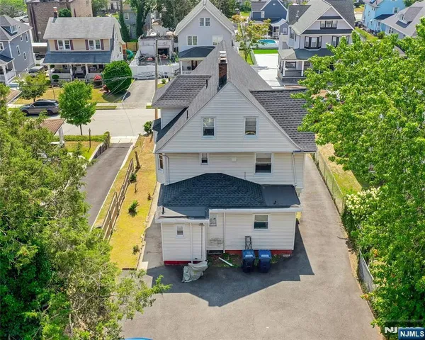 an aerial view of a house with a yard
