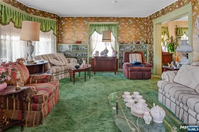 a living room with furniture fireplace and a large window