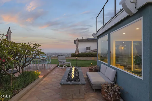 a backyard of a house with table and chairs