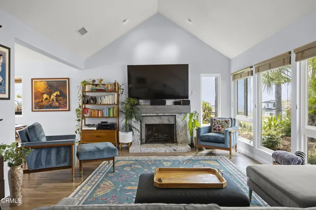 a living room with furniture and a fireplace