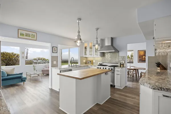 a kitchen that has a stove a sink and a refrigerator
