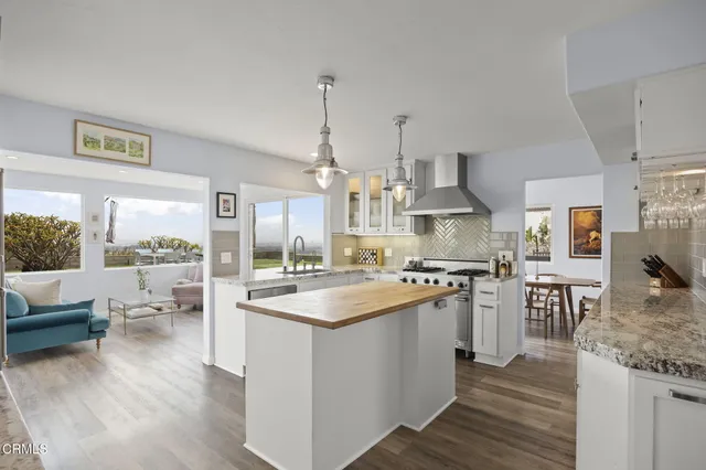 a kitchen that has a stove a sink and a refrigerator